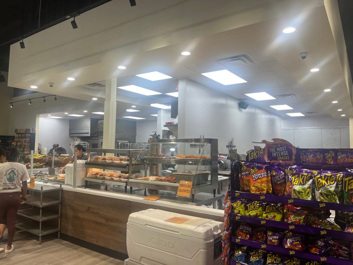 Bakery section with pan dulce cases and Tortillas Calientes sign
